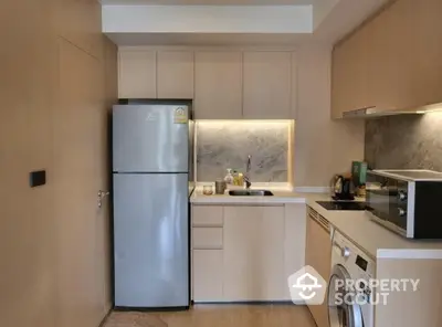 Modern kitchen with sleek appliances and wooden cabinetry