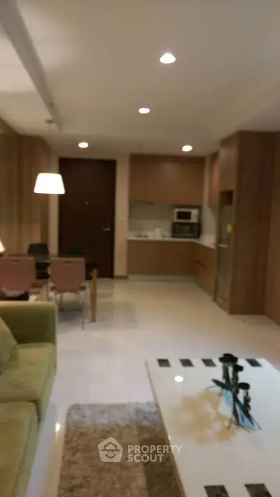 Modern open-layout living room with integrated kitchen and stylish decor