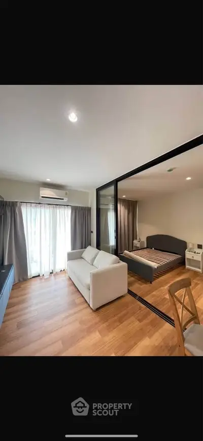 Modern studio apartment with glass partition and cozy furnishings