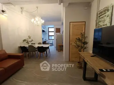 Modern open-plan living room with stylish dining area and contemporary kitchen.