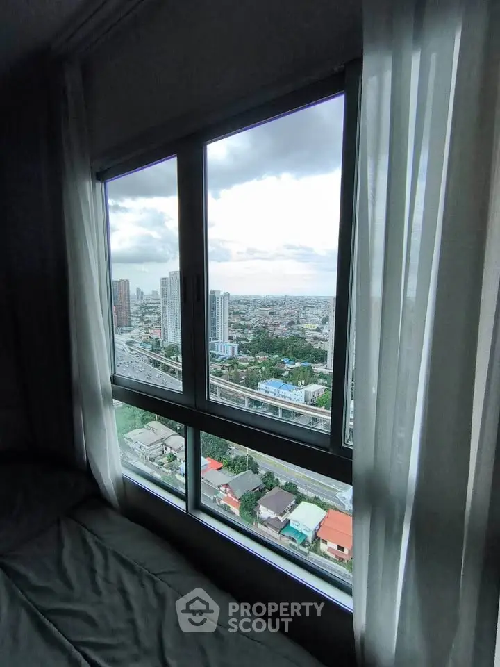 Stunning cityscape view from a high-rise apartment window, showcasing urban living at its finest.