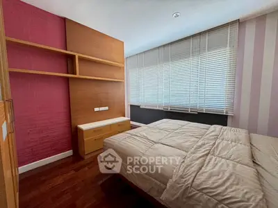 Cozy bedroom with modern decor and ample natural light