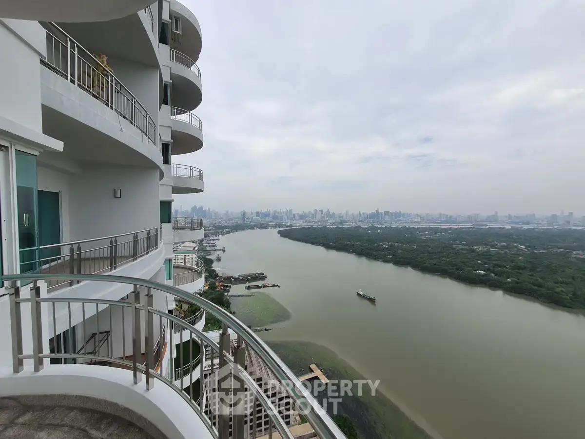 Stunning high-rise balcony view overlooking river and city skyline, perfect for urban living enthusiasts.
