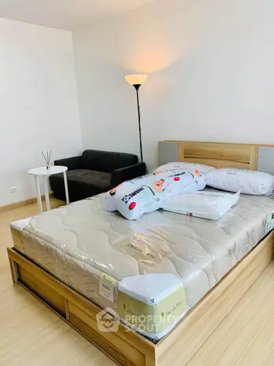 Spacious bedroom with modern furniture and cozy lighting, perfect for relaxation and comfort.