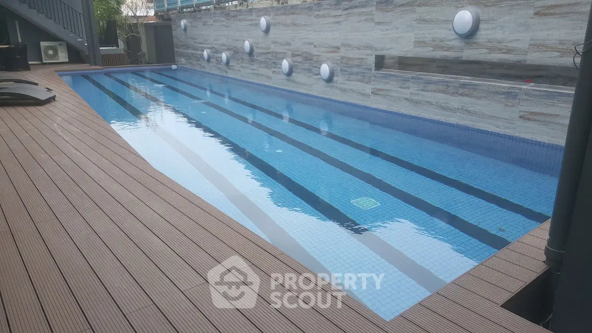 Luxurious outdoor swimming pool with modern design and elegant wooden deck