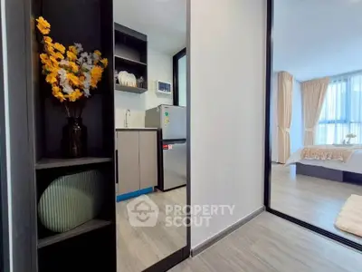 Modern apartment interior with sleek kitchen and cozy bedroom view