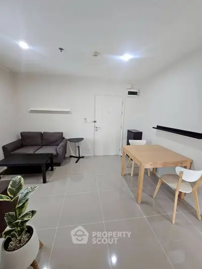 Modern living room with sleek furniture and bright lighting, perfect for urban living.