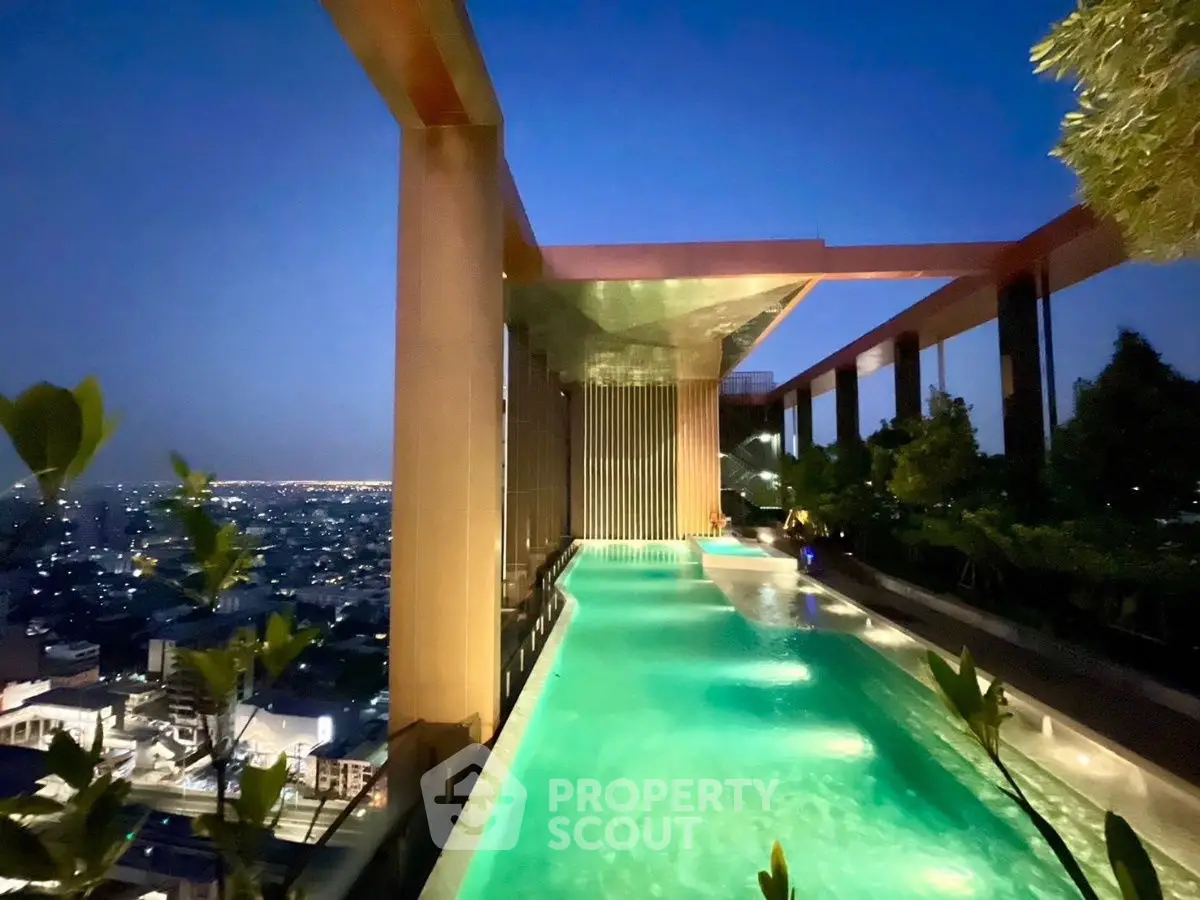 Luxurious rooftop pool with stunning city view at dusk, perfect for relaxation and entertainment.