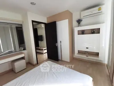 Modern bedroom with sleek design, featuring built-in storage and air conditioning, perfect for urban living.
