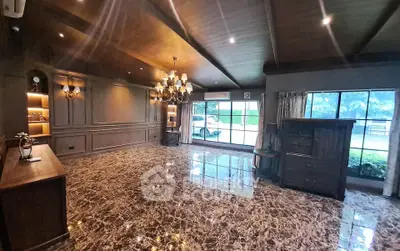 Luxurious living room with marble flooring and elegant chandelier in a spacious open layout.