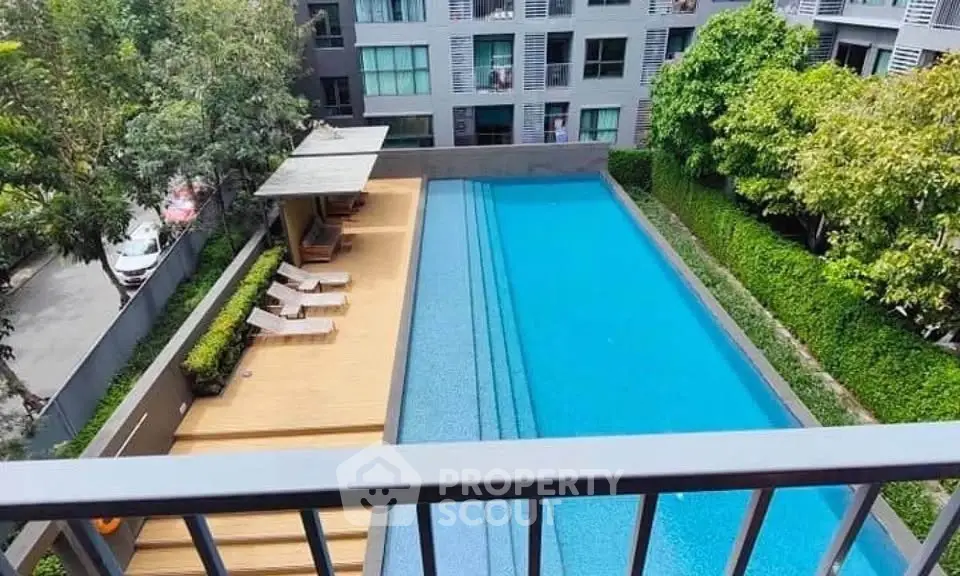 Luxurious apartment complex with stunning pool view and lush greenery
