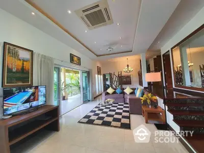 Spacious living room with modern decor and large balcony access