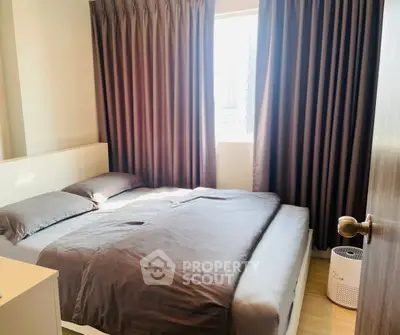 Cozy bedroom with natural light and modern furnishings, perfect for relaxation.