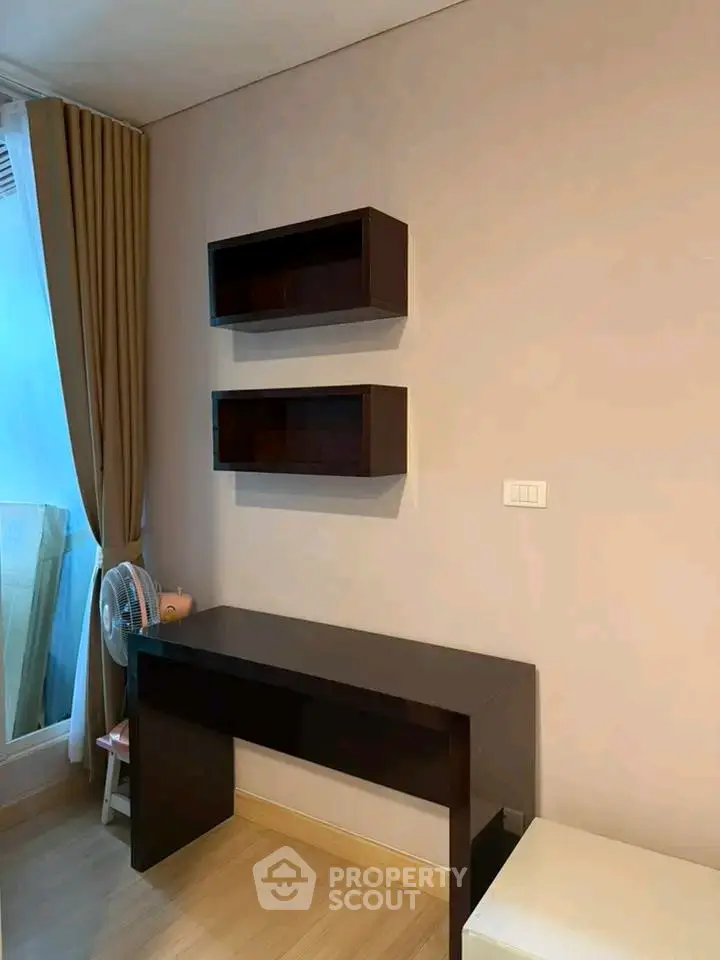 Modern study area with sleek desk and shelves, perfect for productivity.