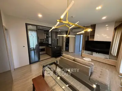 Modern living room with stylish lighting and open kitchen layout