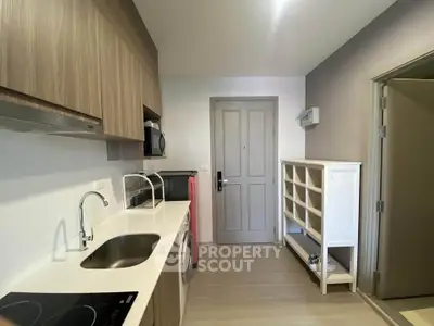 Modern kitchen with sleek cabinetry and built-in appliances in a stylish apartment.
