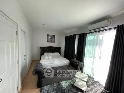 Stylish bedroom with plush furnishings and natural light