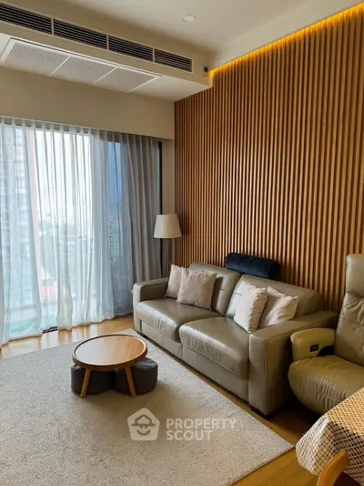 Modern living room with stylish wooden panel wall and cozy seating area