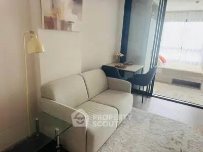 Modern apartment interior with cozy living room and stylish bedroom, featuring elegant decor and natural light.