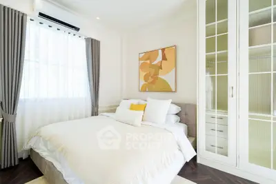 Bright and cozy bedroom with elegant decor and ample natural light