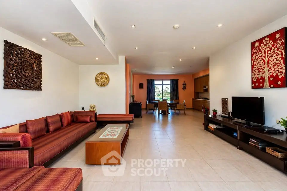 Spacious living room with elegant decor and open layout, featuring modern furniture and ample natural light.