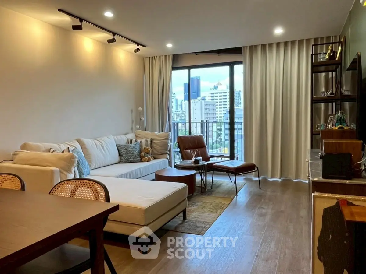 Modern living room with city view, stylish furniture, and cozy ambiance.