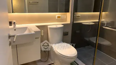 Modern bathroom with sleek fixtures and glass shower enclosure