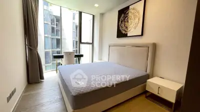 Modern bedroom with large window and stylish decor in luxury apartment
