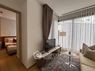 Modern living room with stylish decor and large windows in a contemporary apartment.