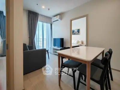 Modern open-plan living and dining area with natural light and stylish furnishings.