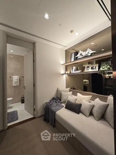 Luxurious modern living space with cozy seating and elegant decor, adjacent to a stylish bathroom.