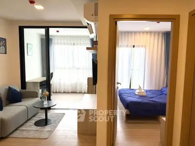 Modern apartment interior with cozy living room and stylish bedroom, featuring elegant decor and natural light.