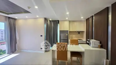 Modern open-layout kitchen with dining area and natural light in a stylish apartment.
