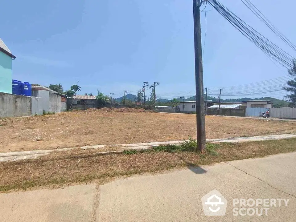 Expansive vacant lot in a developing neighborhood, perfect for building a dream home or investment property with clear skies and potential.