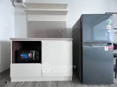Modern kitchen with sleek fridge and microwave in stylish apartment