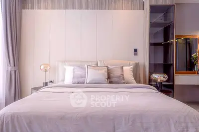 Luxurious bedroom with elegant decor and soft lighting, perfect for relaxation and comfort.
