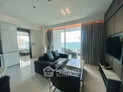 Modern living room with ocean view, sleek furniture, and large windows in a luxury apartment.