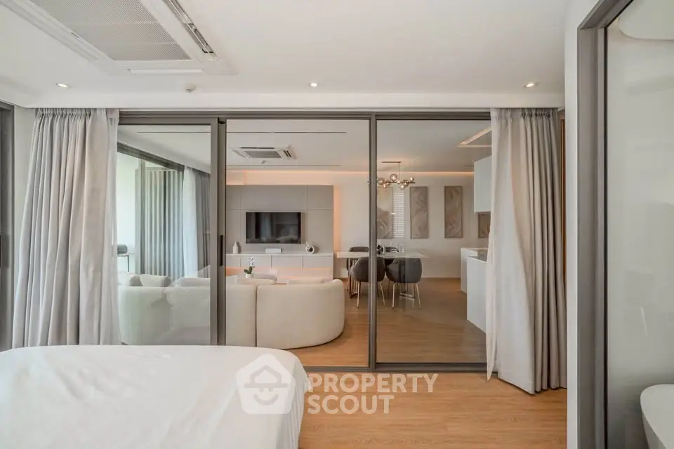 Modern open-plan living room with glass sliding doors and elegant decor