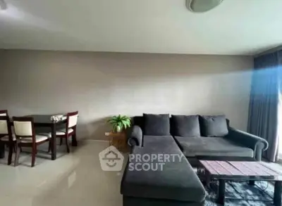 Spacious living room with modern furniture and natural light, perfect for relaxation and entertainment.