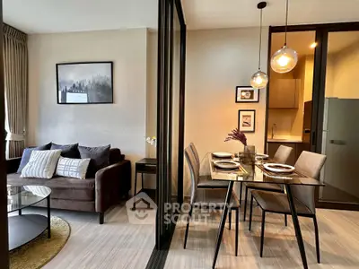 Modern open-plan living and dining area with stylish decor and natural lighting.