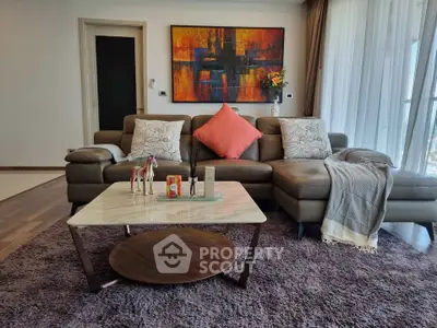 Luxurious living room with modern decor, plush sofa, and abstract art, perfect for stylish urban living.