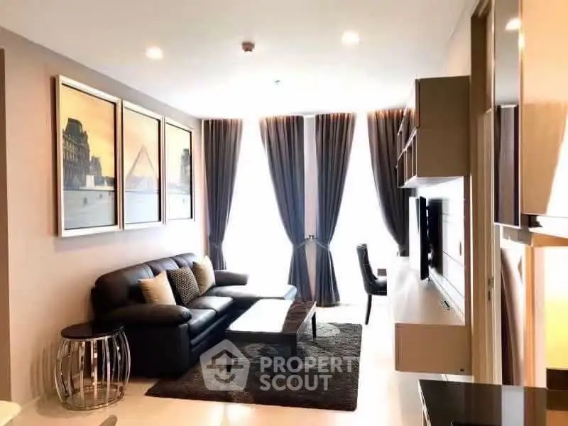 Modern living room with elegant decor, large windows, and stylish furniture in a cozy apartment.