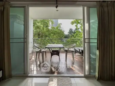 Spacious balcony with outdoor seating and lush greenery view