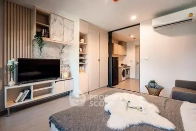 Modern living room with stylish decor and open layout, featuring a cozy sofa and elegant shelving.