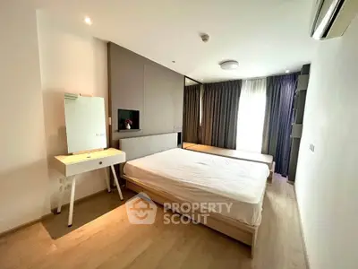 Modern bedroom with minimalist design, featuring a large bed, stylish vanity, and ample natural light.