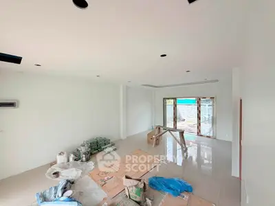 Spacious under-construction living room with large windows and modern design.