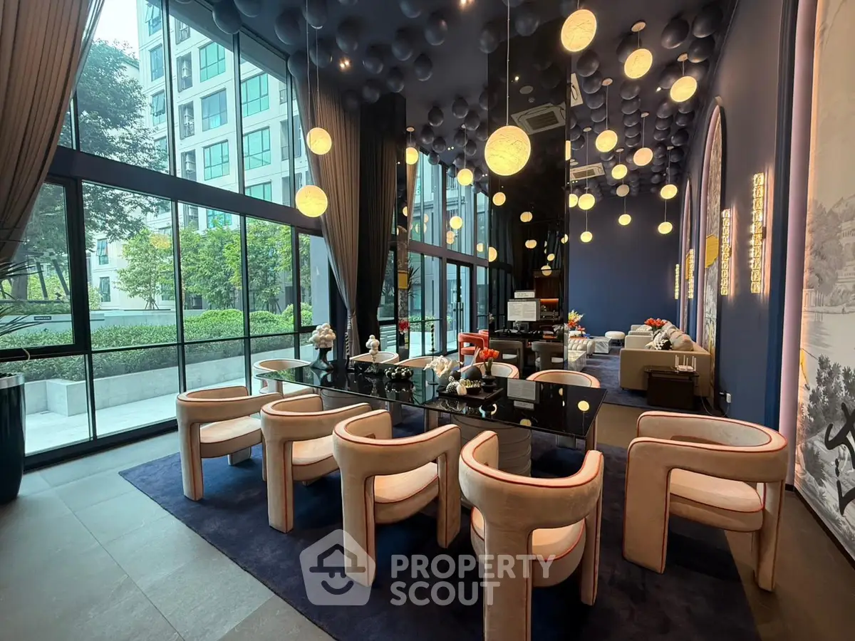 Luxurious modern living room with high ceilings and elegant lighting in a stylish apartment building.