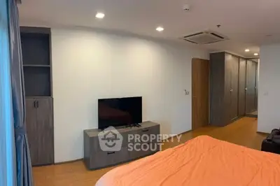 Modern bedroom with sleek furniture and built-in wardrobe