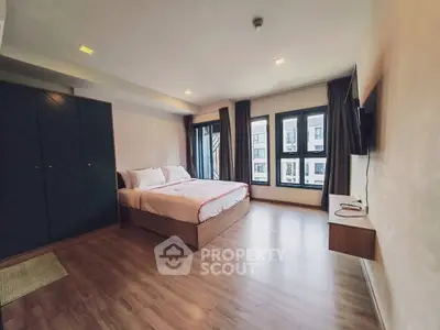Spacious modern bedroom with large windows and stylish decor