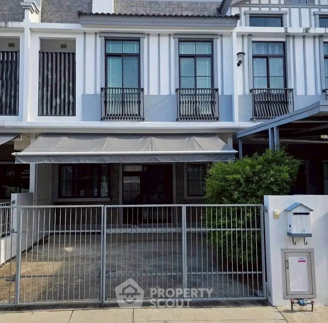 Modern townhouse exterior with gated entrance and stylish facade